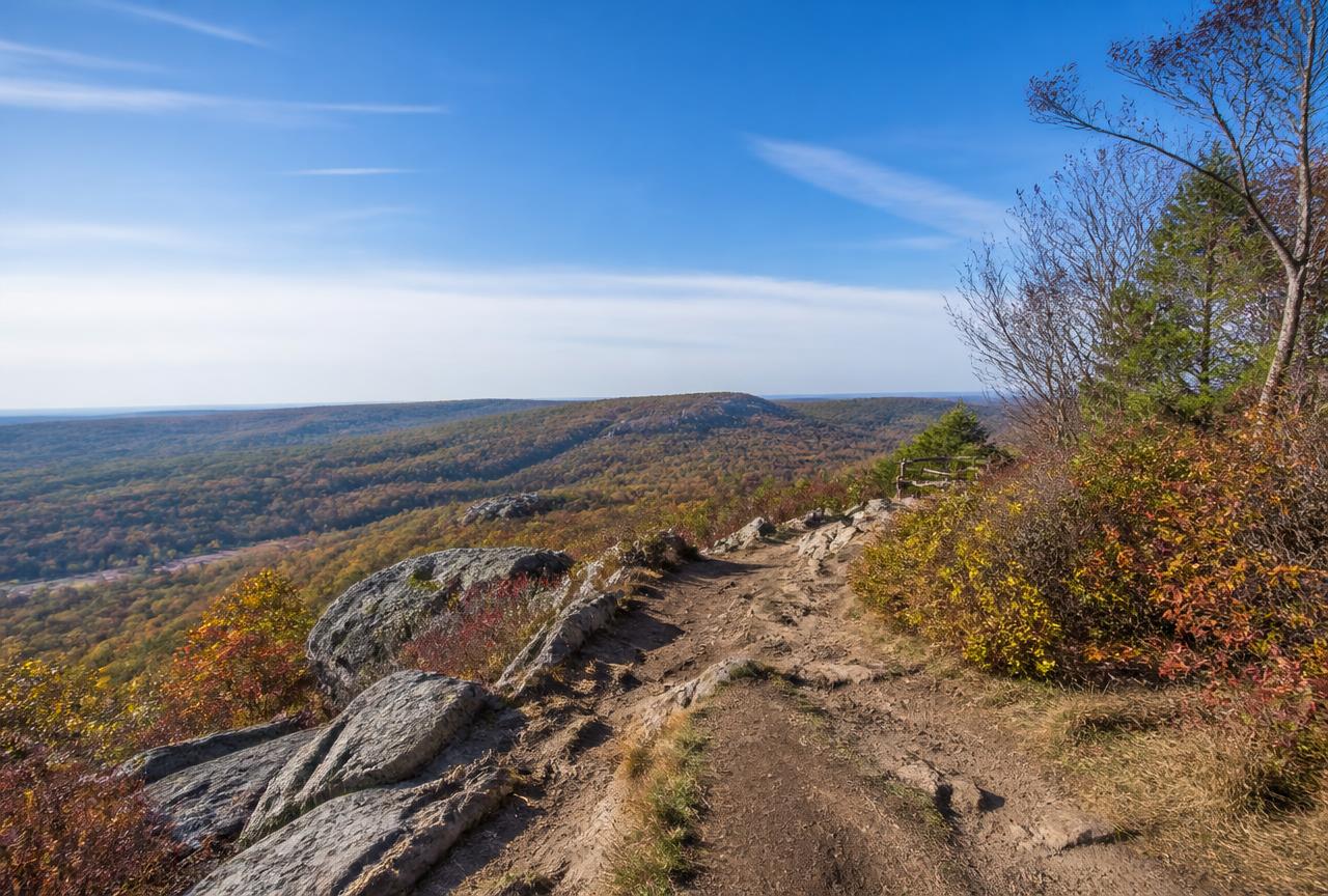 Rocky ledge hiking trail with views over autumn forest at Diamond Hill in Cumberland, Rhode Island
