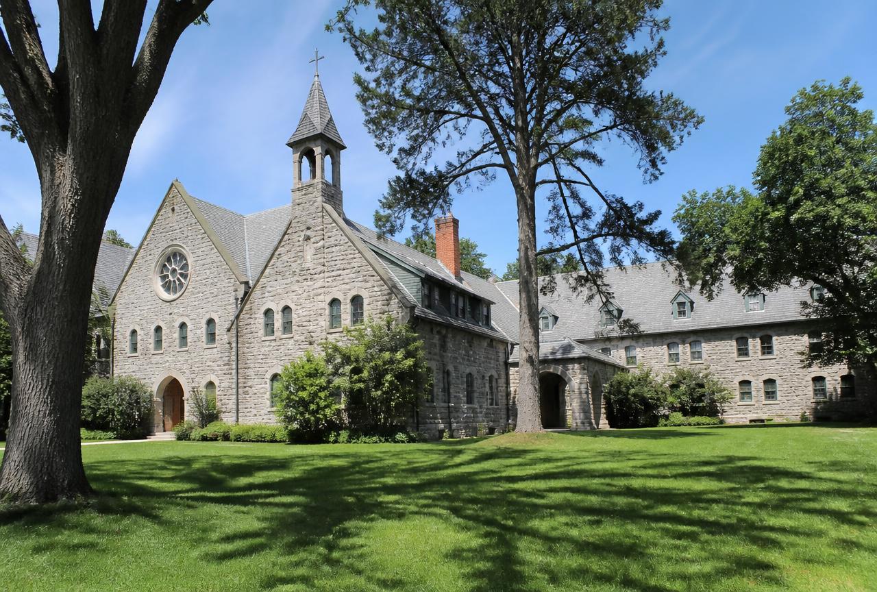 Historic stone Cumberland Monastery building and lawn in Cumberland, Rhode Island