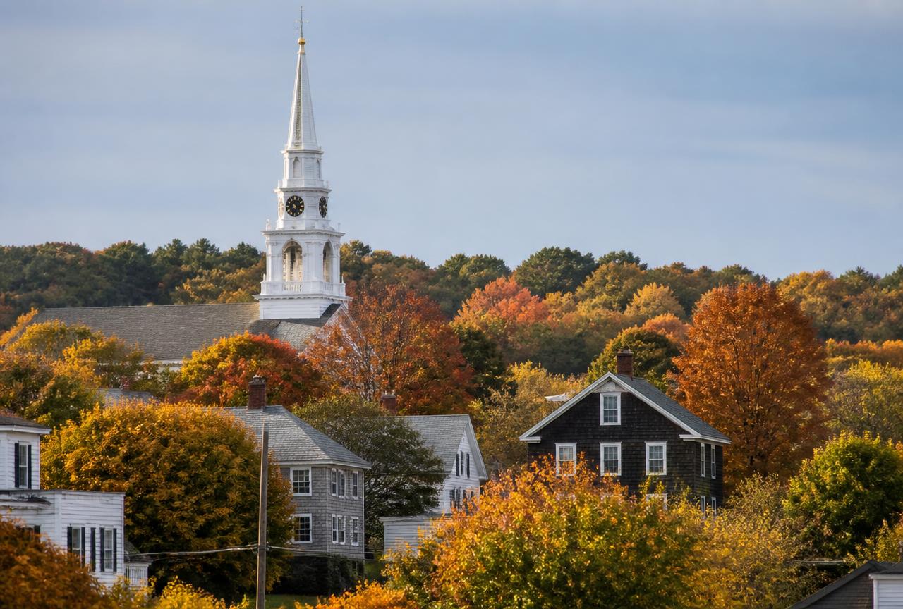 White church steeple above autumn foliage in a Scituate, Rhode Island village